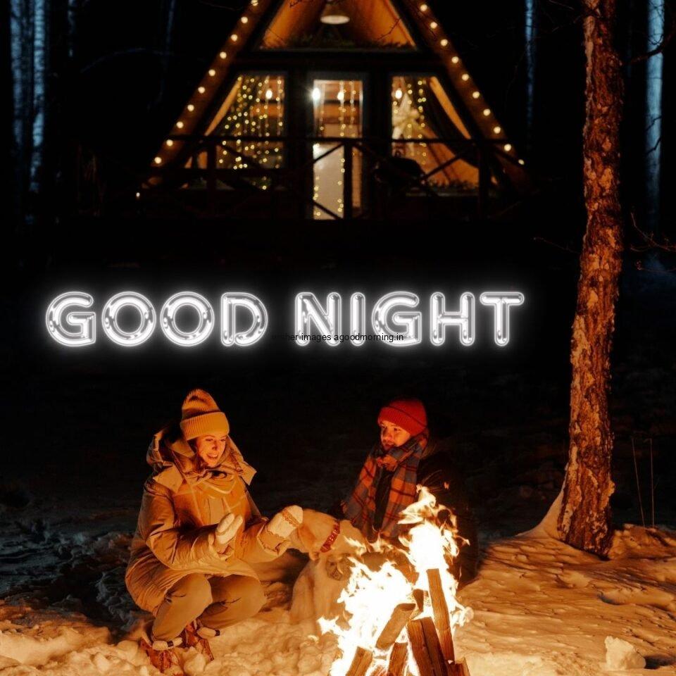 couople see eachother in the night infront of the fire beautifull background with good night placed on the top good night image