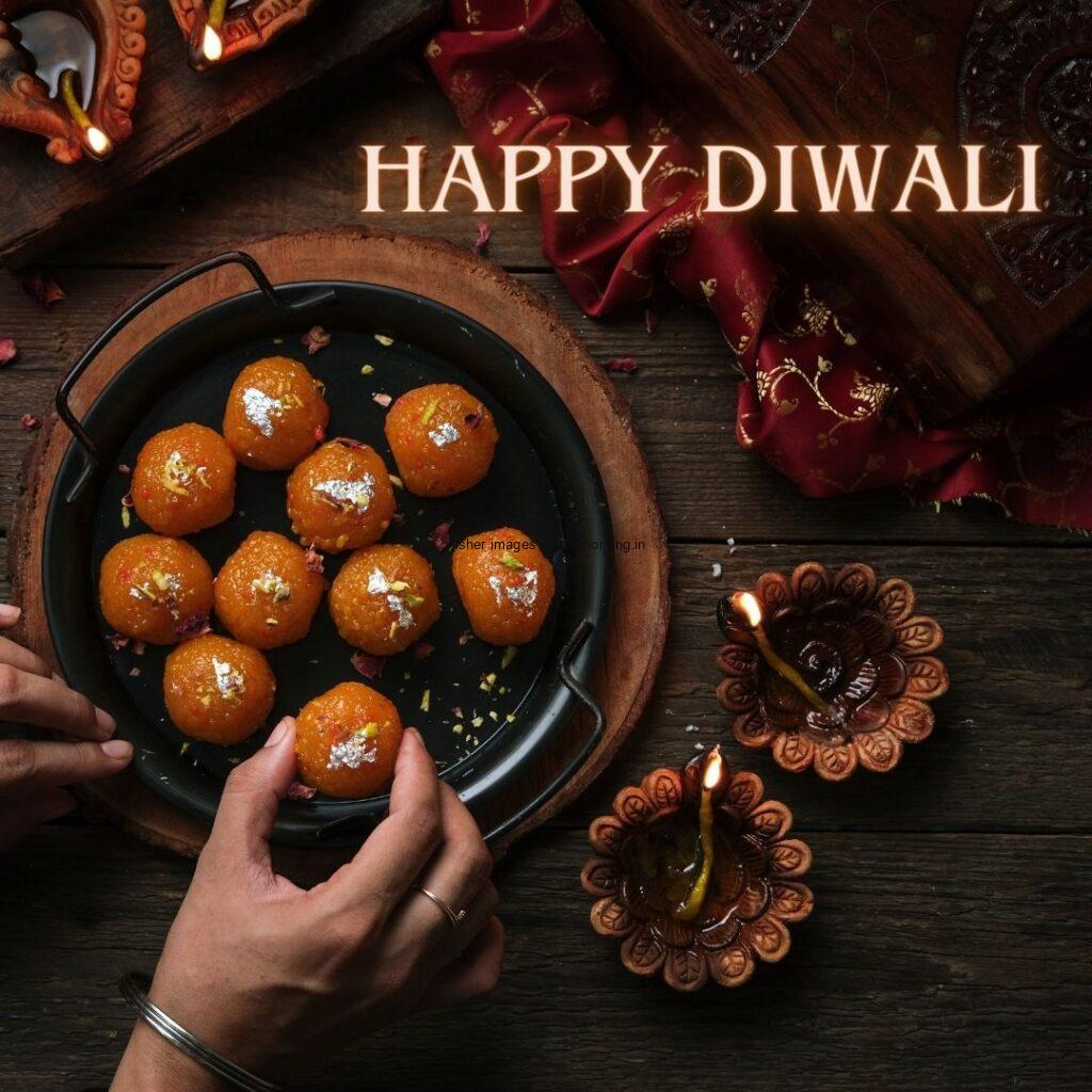 dark background diya or laado in the plate happy diwali image