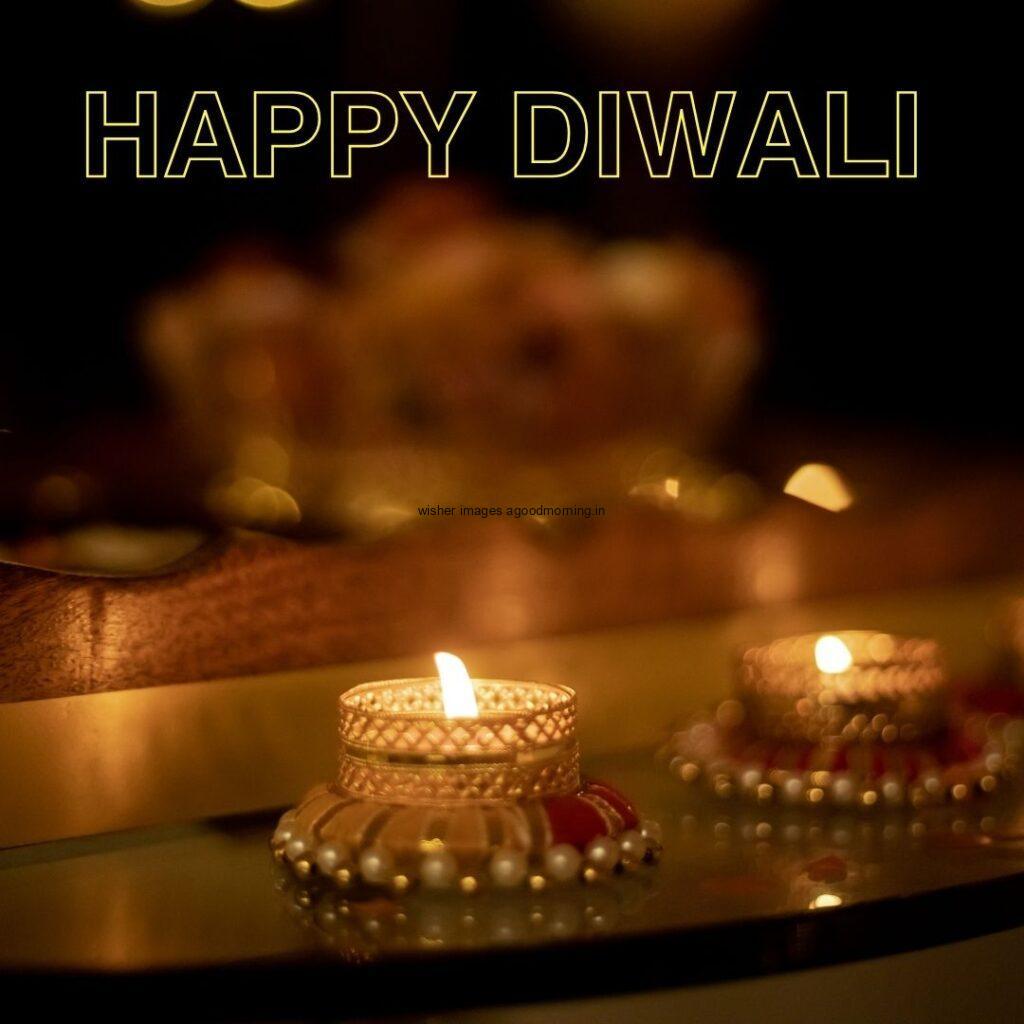 dark background with diya with flowers placed on plate happy diwali image