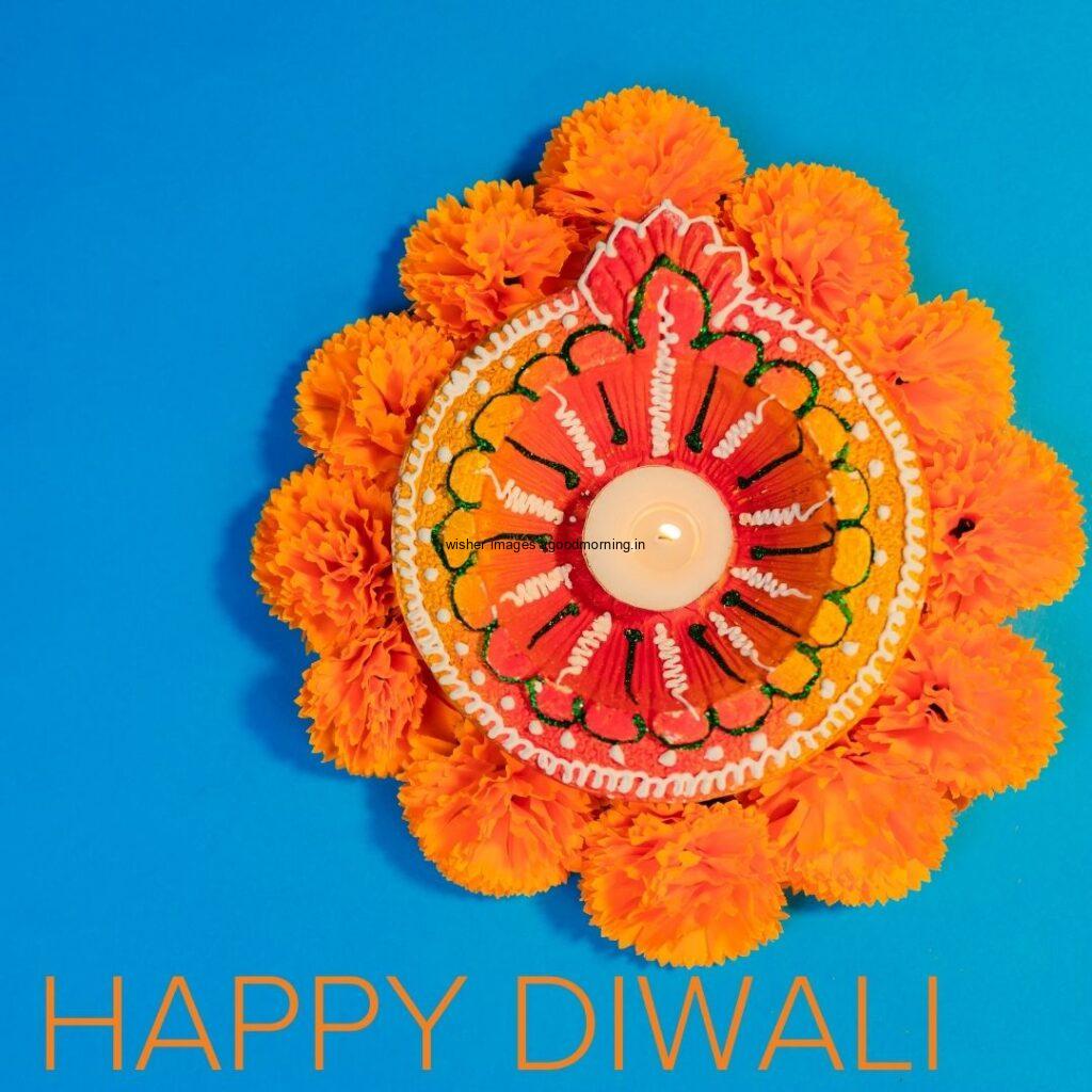 dark blue background with big colourful diya with flowers happy diwali image