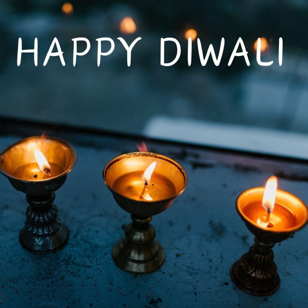 dark grey background with diya placed on plate happy diwali image