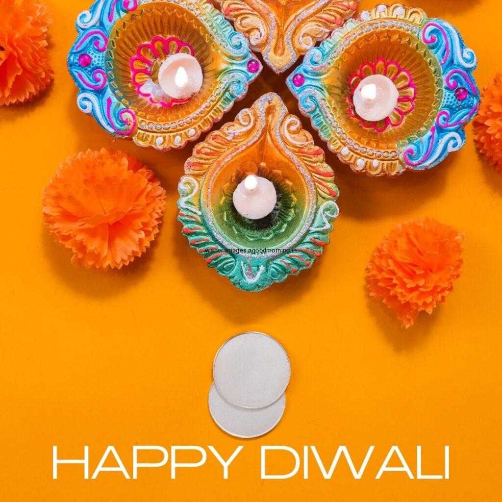 dark yellow background with colourful diya with flowers happy diwali image