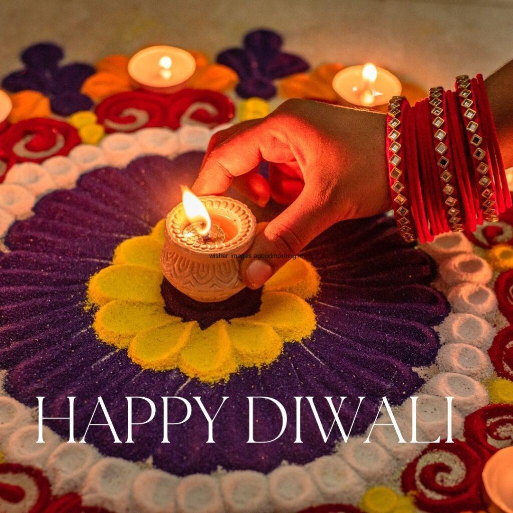 light diya inside the rangloi by holding the hand happy diwali images