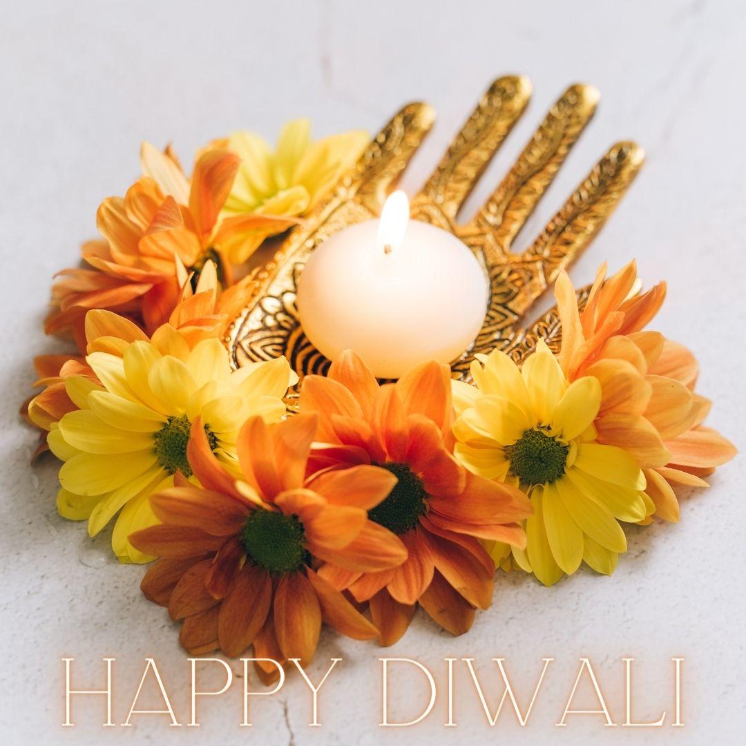 light grey background with colourful diya with flowers happy diwali image
