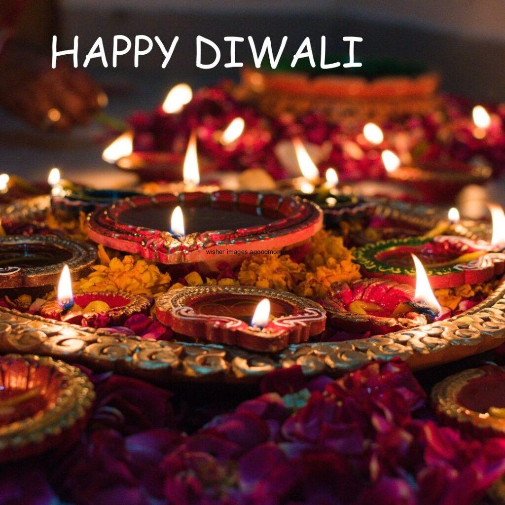 many diya with flowers placed on plate happy diwali image