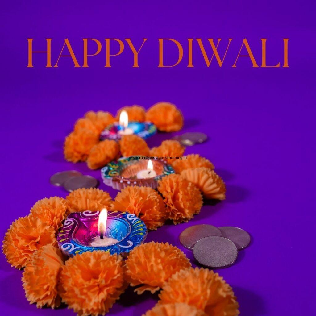 purple background with diya with flowers happy diwali image