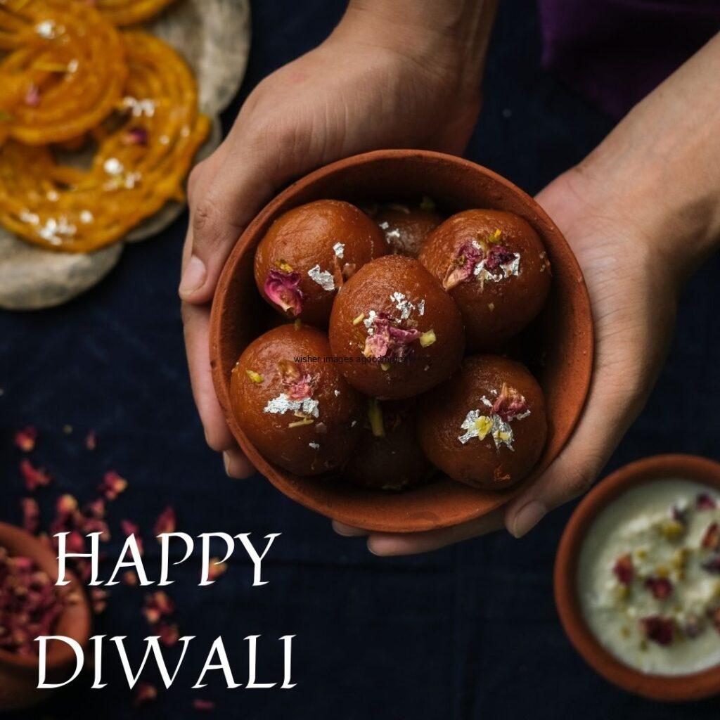 sweet bowl in the hand with happy diwali image