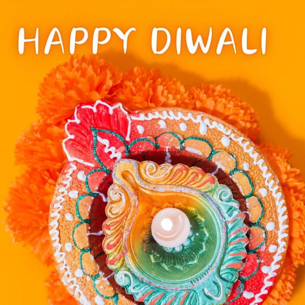 yellow background with colourful big diya with flowers happy diwali image